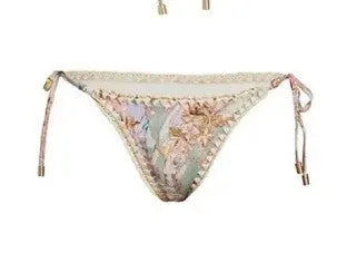 Creamy white floral print women's bikini set with attached skirt, showing top, briefs, and skirt components