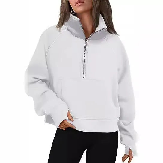 A woman wearing a loose-fitting apricot-coloured fleece-lined sweater with a lapel neckline and raglan sleeves.