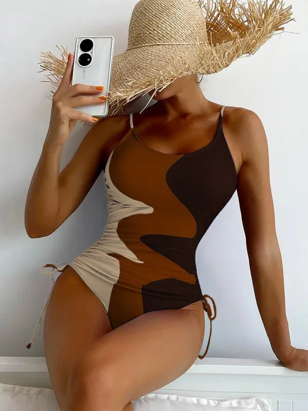 Women's sleeveless one-piece swimsuit in blue with striped pattern, backless design.