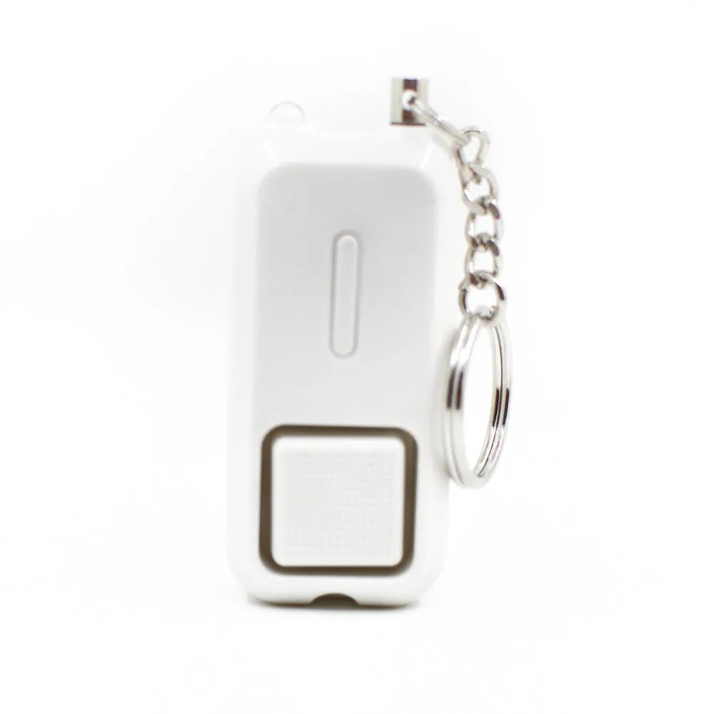 Small pink personal safety alarm on a keyring with a pull-pin activation mechanism.