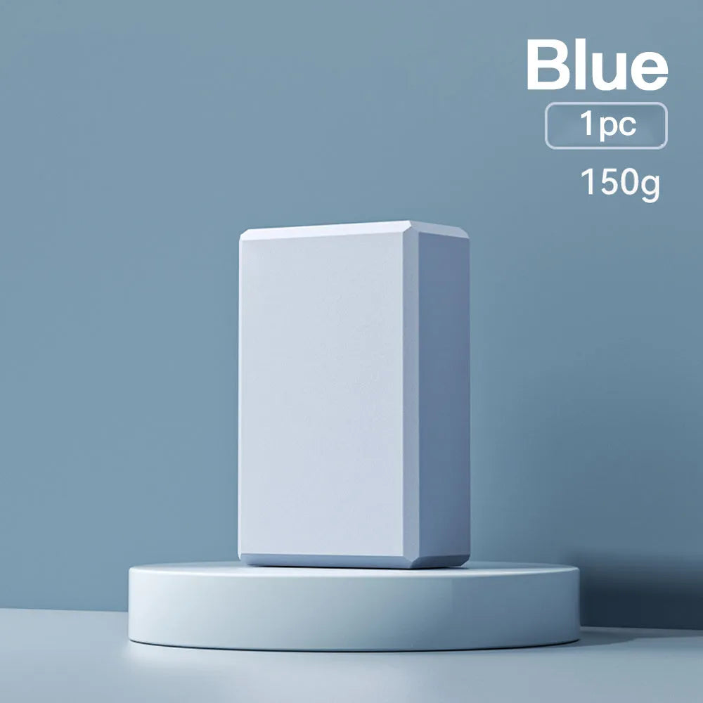 Solid colour high-density EVA yoga block on a gym floor.