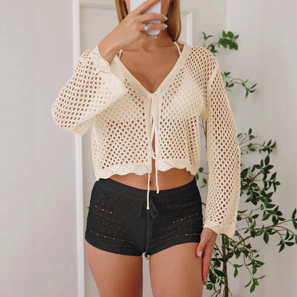 Short women's cardigan blouse with bell sleeves in hollow woven fabric, shown in black colour