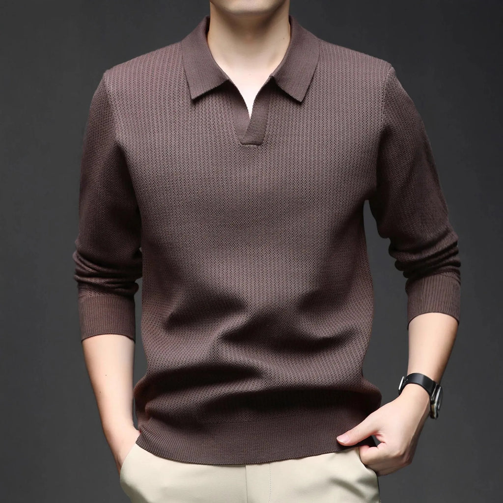Man wearing a loose green casual pullover sweater, showing the simple long-sleeve design.