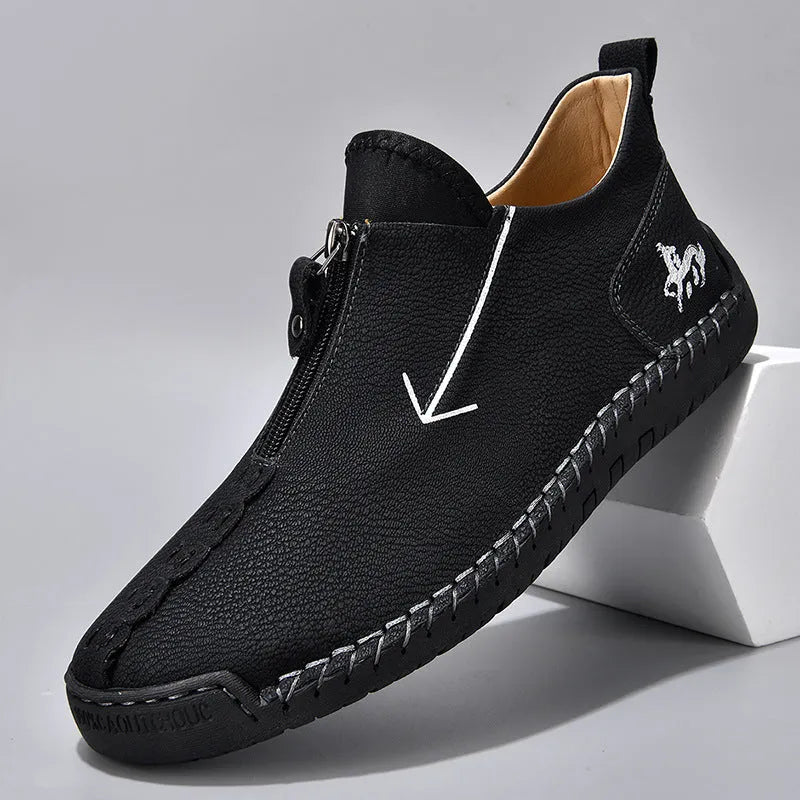 Men's brown zip-up Martin boots with round toe and hand-stitched rubber sole on a neutral background.