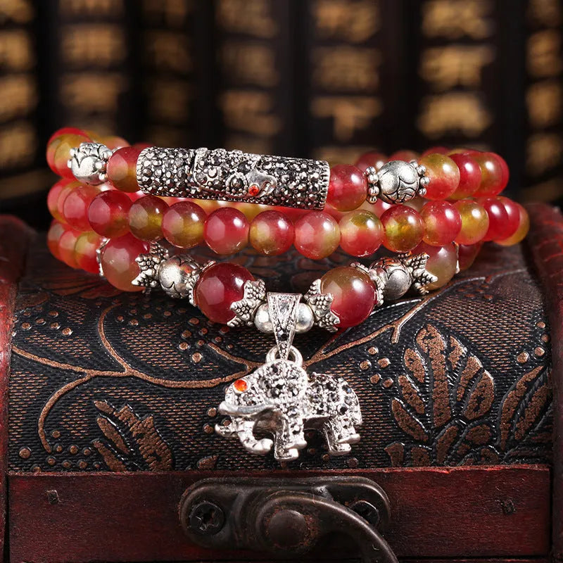 Watermelon crystal bracelet with Chinese knot design showing elephant style beads in geometric shape