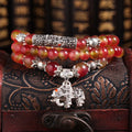 Watermelon crystal bracelet with Chinese knot design showing elephant style beads in geometric shape