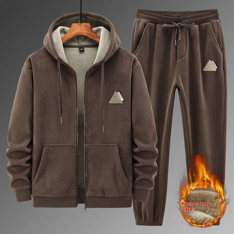 Grey hooded sweater and matching cotton trousers casual sport suit laid flat