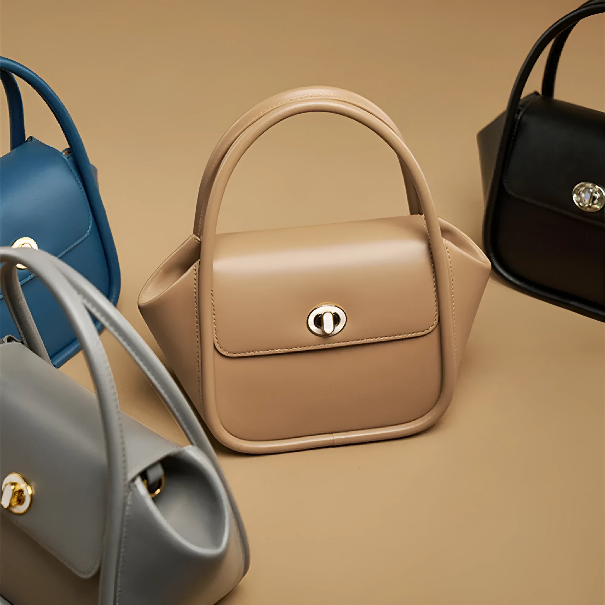 Women's leather wing tote bag in cow leather with a cross-body strap and buckle detail.