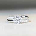 Silver ring with twisted band and 1 carat moissanite stone in four-claw setting