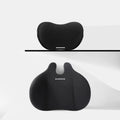 Cow head style black automotive headrest pillow and matching lumbar support pillow on a car seat.
