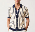 Man wearing a white asymmetric lapel knitted polo shirt with a striped pattern.