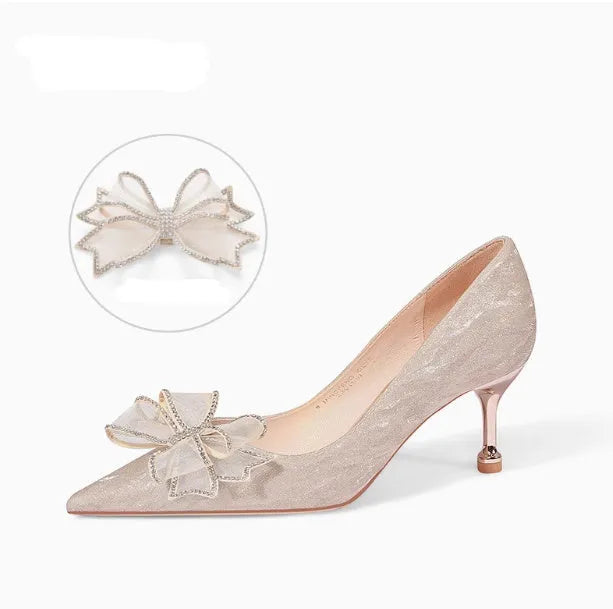 Champagne coloured sequinned pointed toe stiletto high heel pump on a white background.