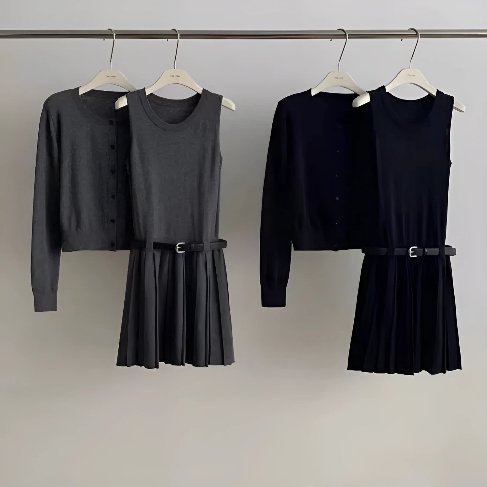 Grey women's knitted vest skirt and cardigan two-piece set with 3D pattern and belt.