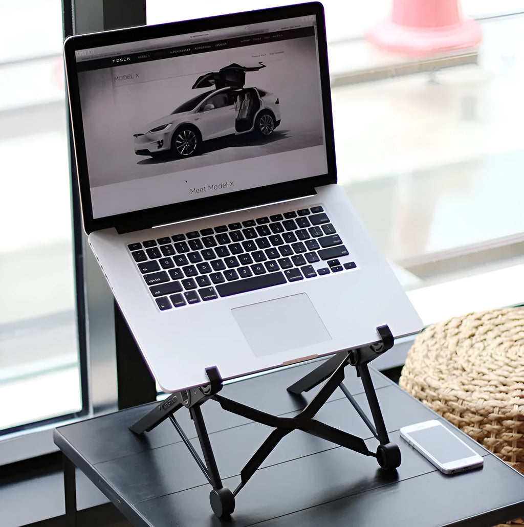 Black folding portable laptop stand made from reinforced nylon, shown folded to its compact size.