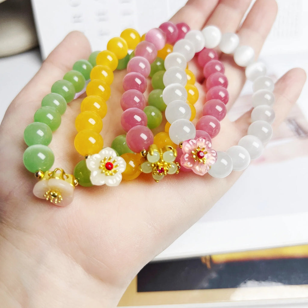 Handmade women's glass beaded bracelet with flower elements in multiple colour options