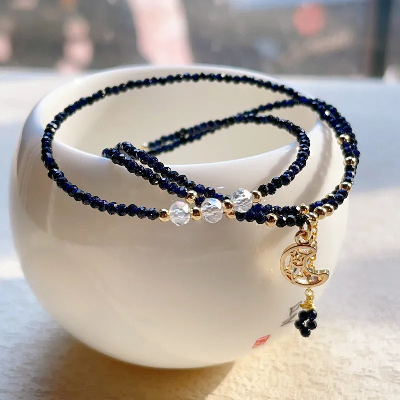 Women's blue sand stone and gold three-ring multi-layer bracelet on wrist