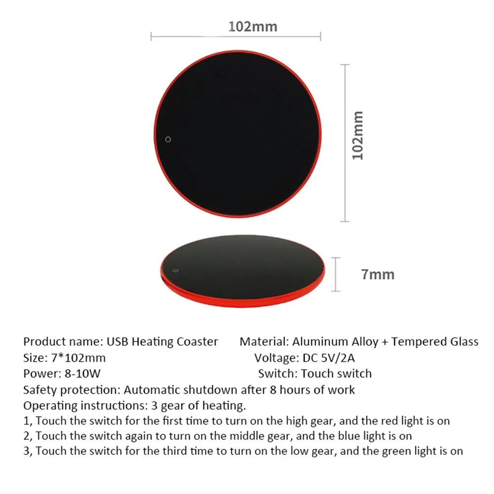 Black USB heating coaster pad for cups with LED indicator light on a wooden desk.