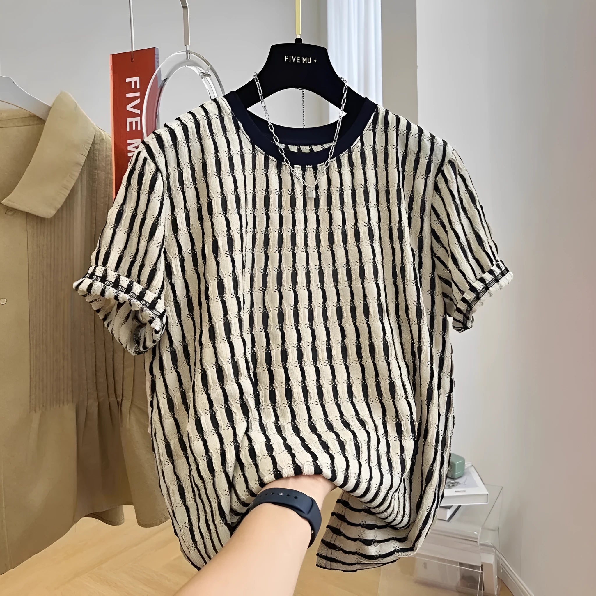 Black and white striped men's loose fit short sleeve pullover shirt made from linen silk blend fabric.