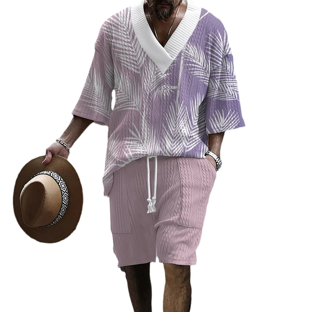 Man wearing a light blue printed drop-shoulder knitted top with matching shorts from a casual summer suit.