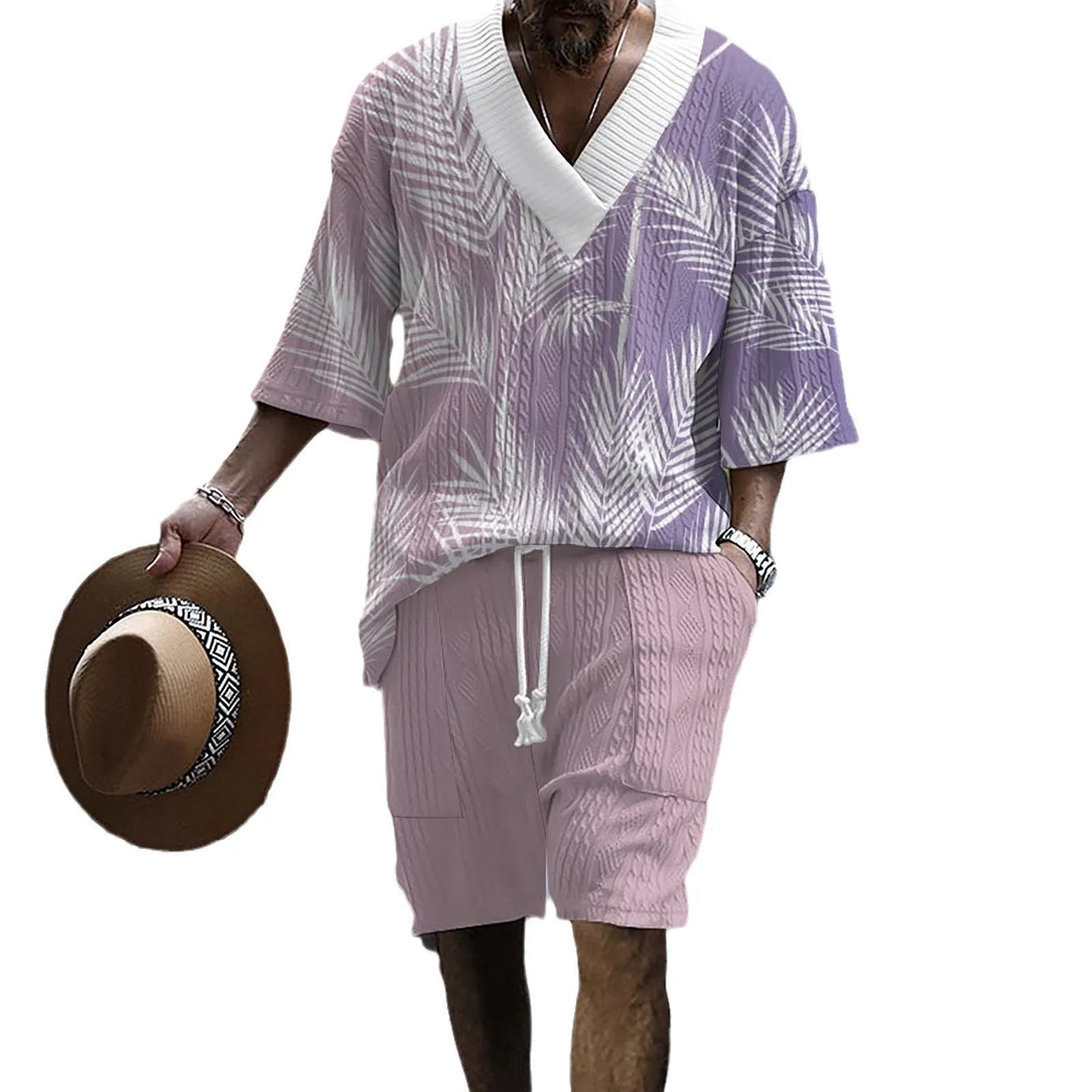 Man wearing a light blue printed drop-shoulder knitted top with matching shorts from a casual summer suit.