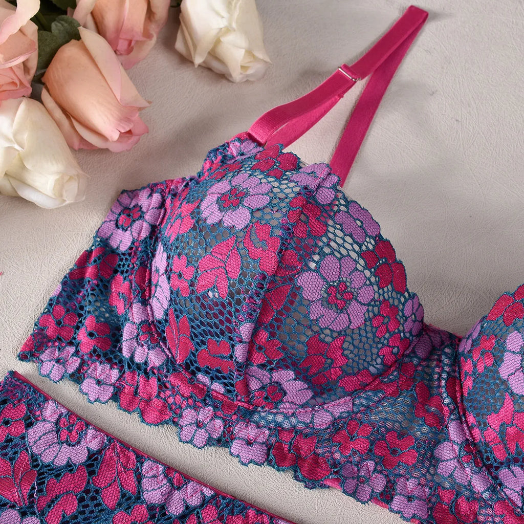 Rose red women's bikini set with floral embroidery on a white background.