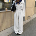 White striped wide-leg casual trousers with a loose fit and zipper detail on a mannequin.