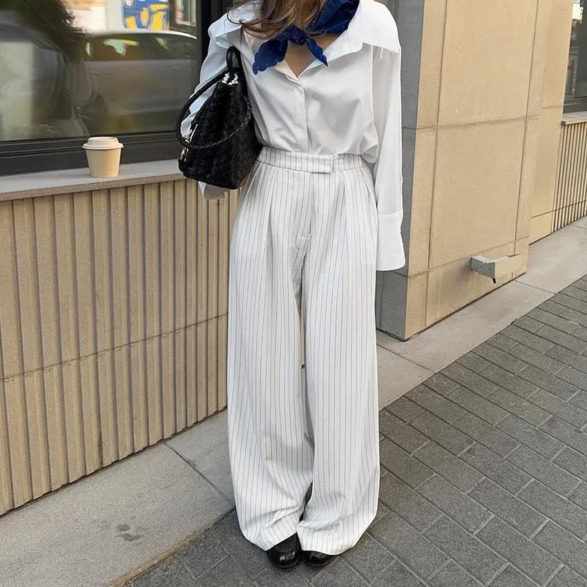 White striped wide-leg casual trousers with a loose fit and zipper detail on a mannequin.