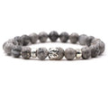 Natural stone stretch bracelet with a carved Tigereye Buddha head bead and 8mm round beads.