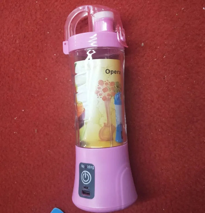 Blue portable handheld USB rechargeable blender with a 400ml clear cup on a table.