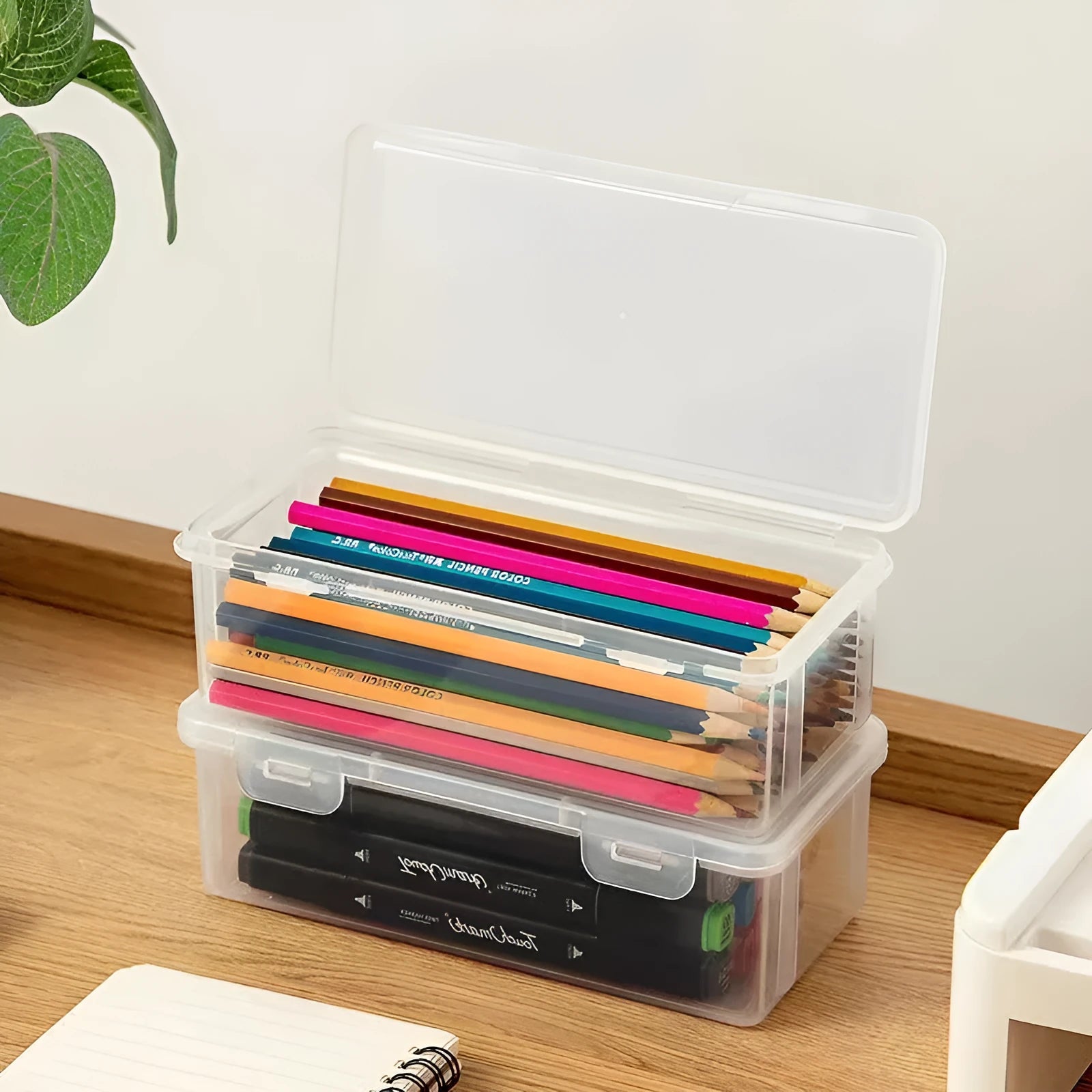Transparent plastic pencil storage box showing interior space for organising stationery