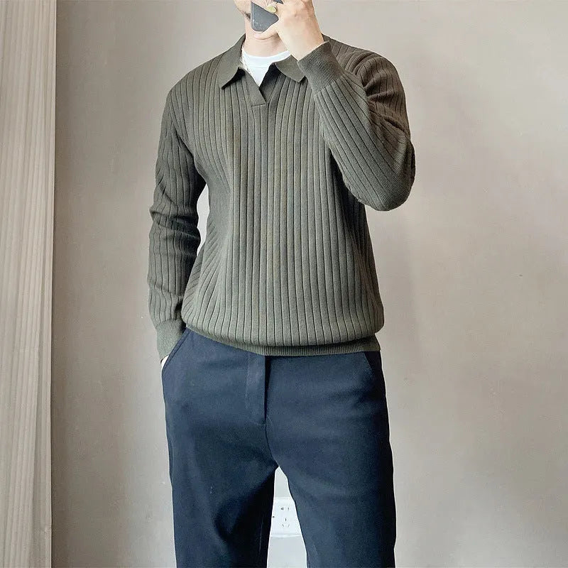 Man wearing a loose striped knitted sweater with a lapel collar in light grey.