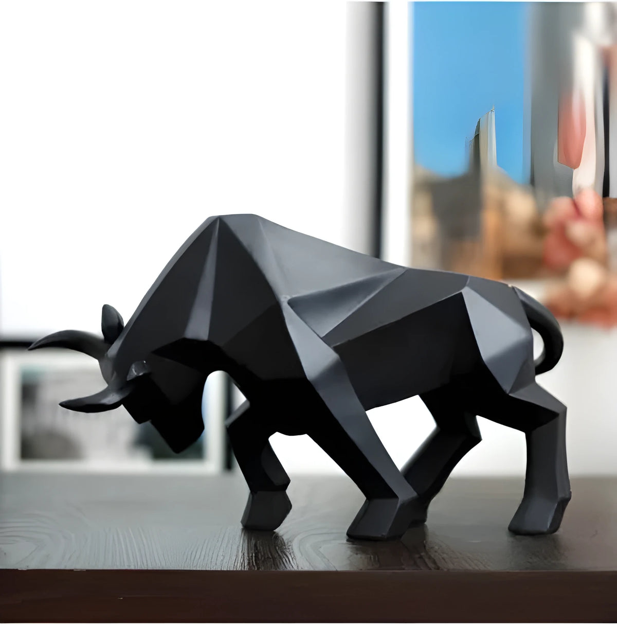 Black geometric resin bull sculpture on a shelf, abstract bison statue for modern home decor