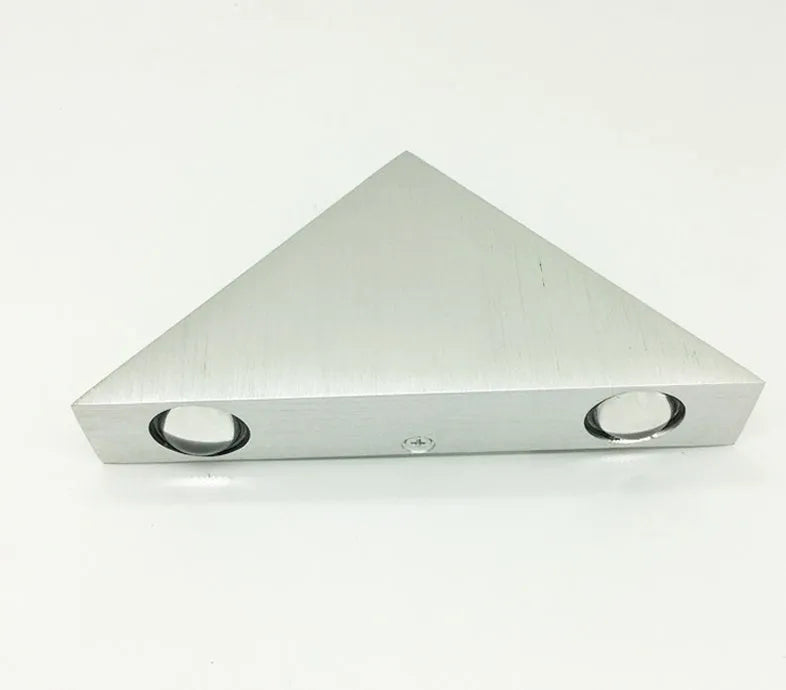 Set of three white LED wall lights with dual heads mounted on a wall showing warm white light