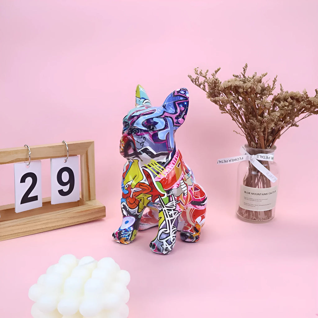Graffiti coloured solid resin French Bulldog statue on a white background.