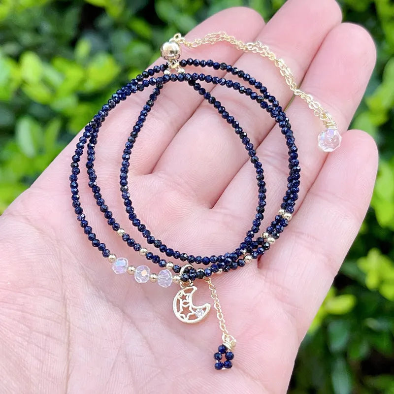 Women's blue sand stone and gold three-ring multi-layer bracelet on wrist