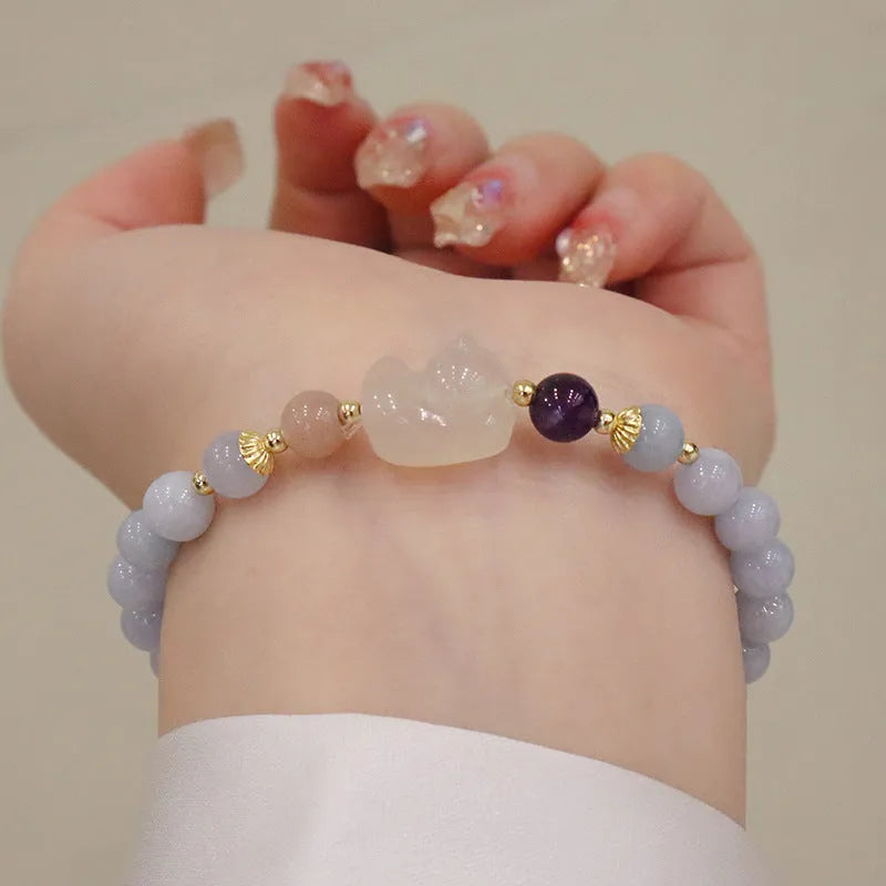 Aquamarine crystal bracelet with gold-plated climbing cat charm for women