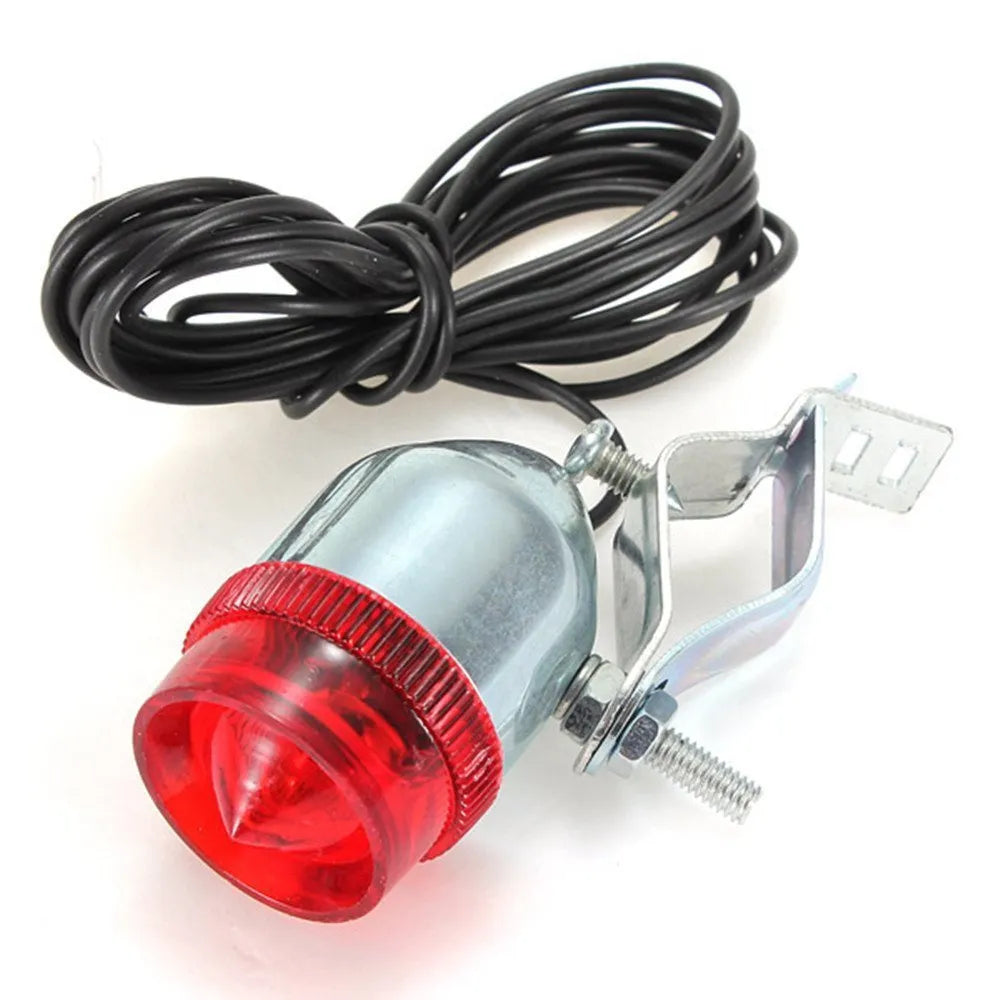 Silver bicycle dynamo generator light kit mounted on a bicycle frame with headlight and taillight.