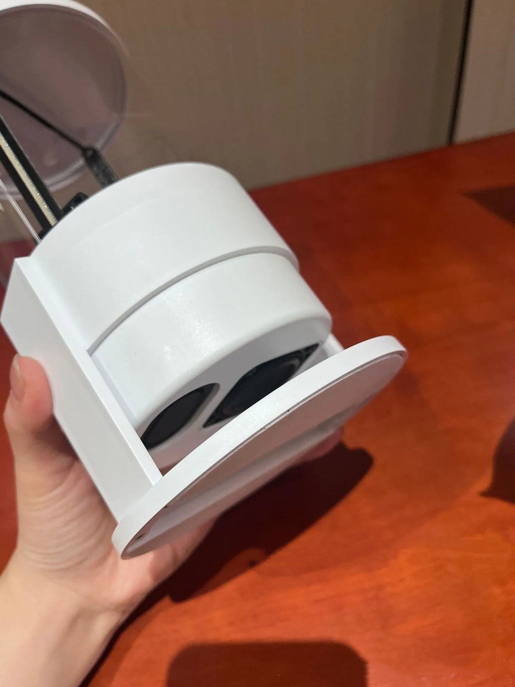 White 360-degree 3D holographic fan Bluetooth speaker with cylindrical screen on a desk