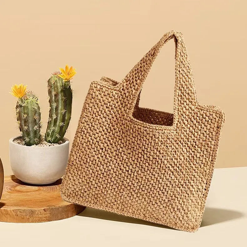Straw woven commuter tote bucket bag with horizontal square shape and woven texture