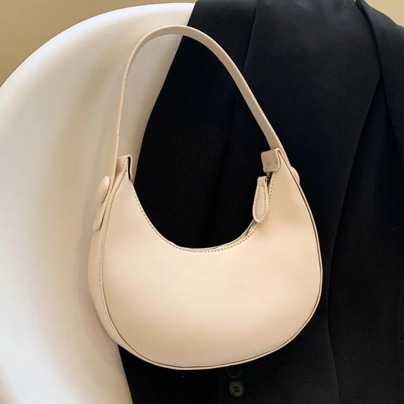 Women's retro dumpling-shaped shoulder bag in PU leather showing internal zipper pocket.