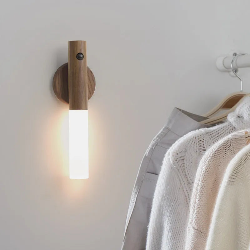 Smart sensor LED desk lamp in solid wood and acrylic, showing compact design beside a charging cable.