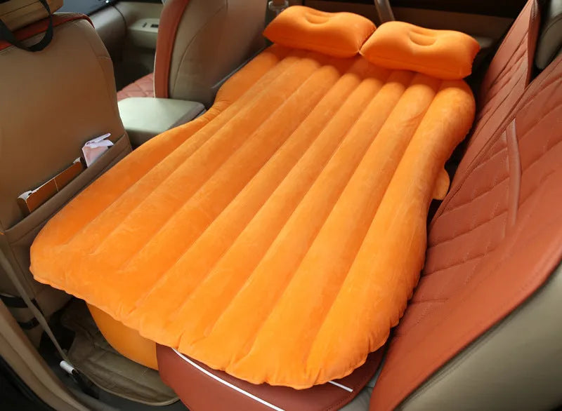 Universal inflatable car bed with flocked cloth, shown with two pillows and a pump.