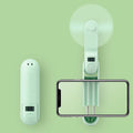 Green folding mini USB fan with plastic blades on a white background.
