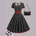 Multicolour polka dot dress with a square collar, short sleeves, front zipper, and pleated skirt.