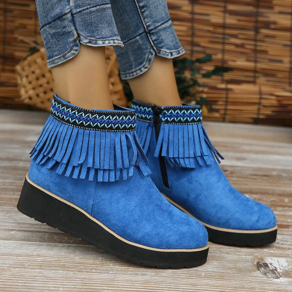 Women's dark brown suede wedge ankle boots with a side zipper and decorative tassels.