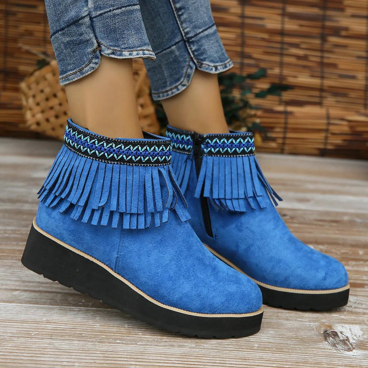 Women's dark brown suede wedge ankle boots with a side zipper and decorative tassels.