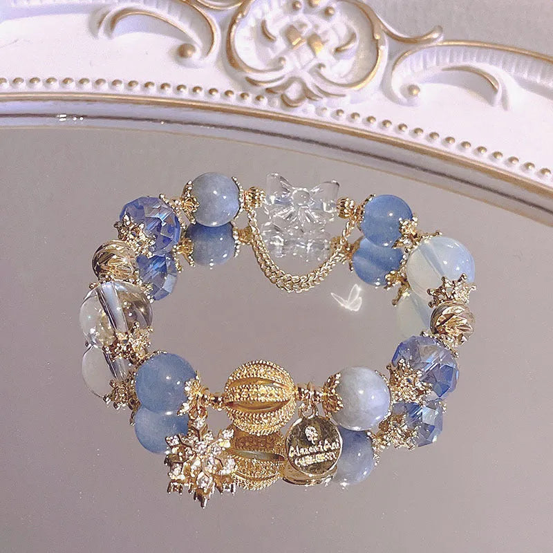 Women's galaxy-coloured alloy bracelet with a snowflake pendant and sweet bow design.