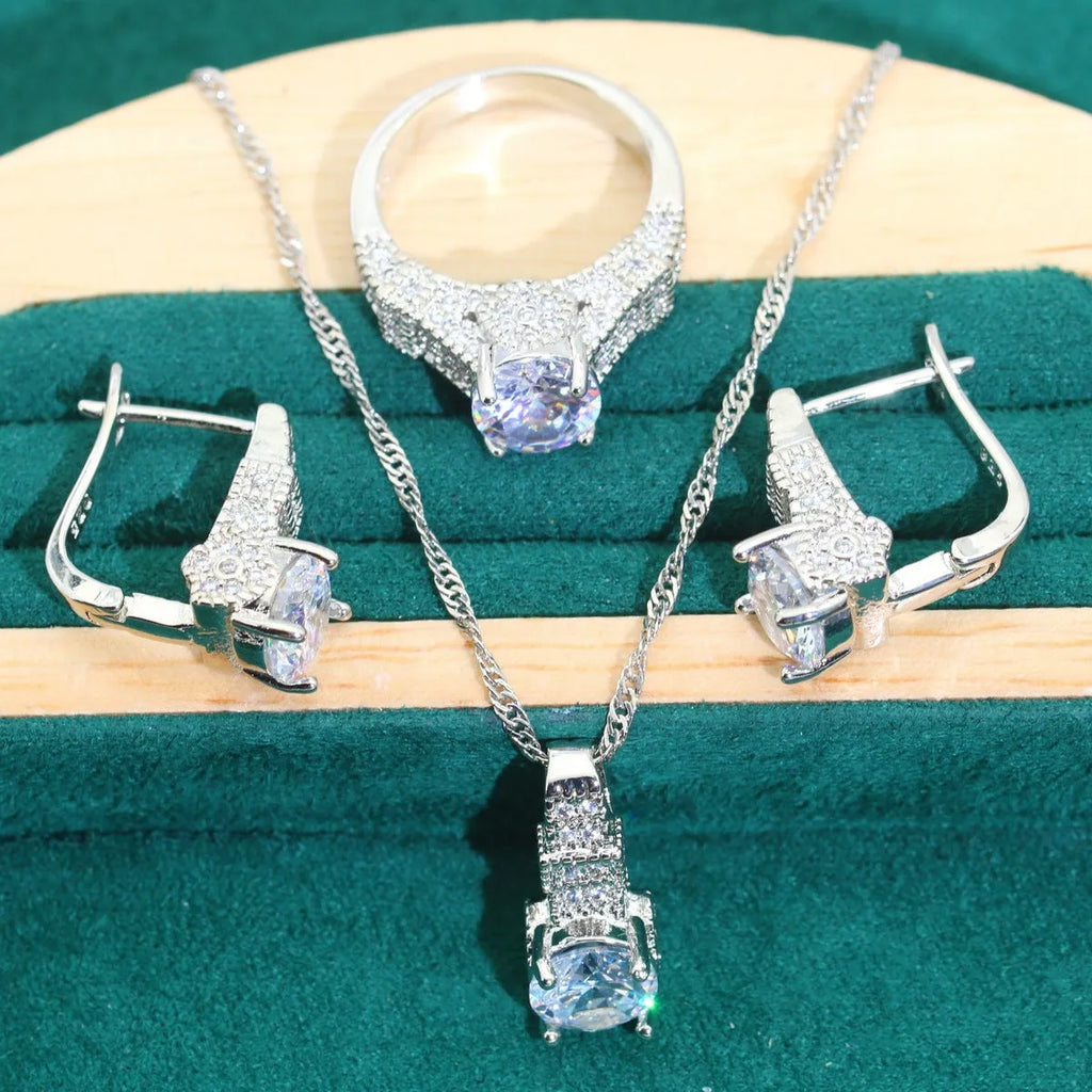Four-piece bridal zircon jewellery set showing necklace, bracelet, earrings, and ring in a choice of colours.