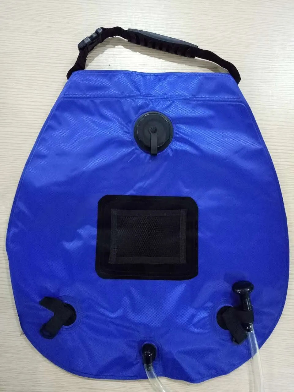 Blue and silver fast-opening camping changing tent set up outdoors with two windows.