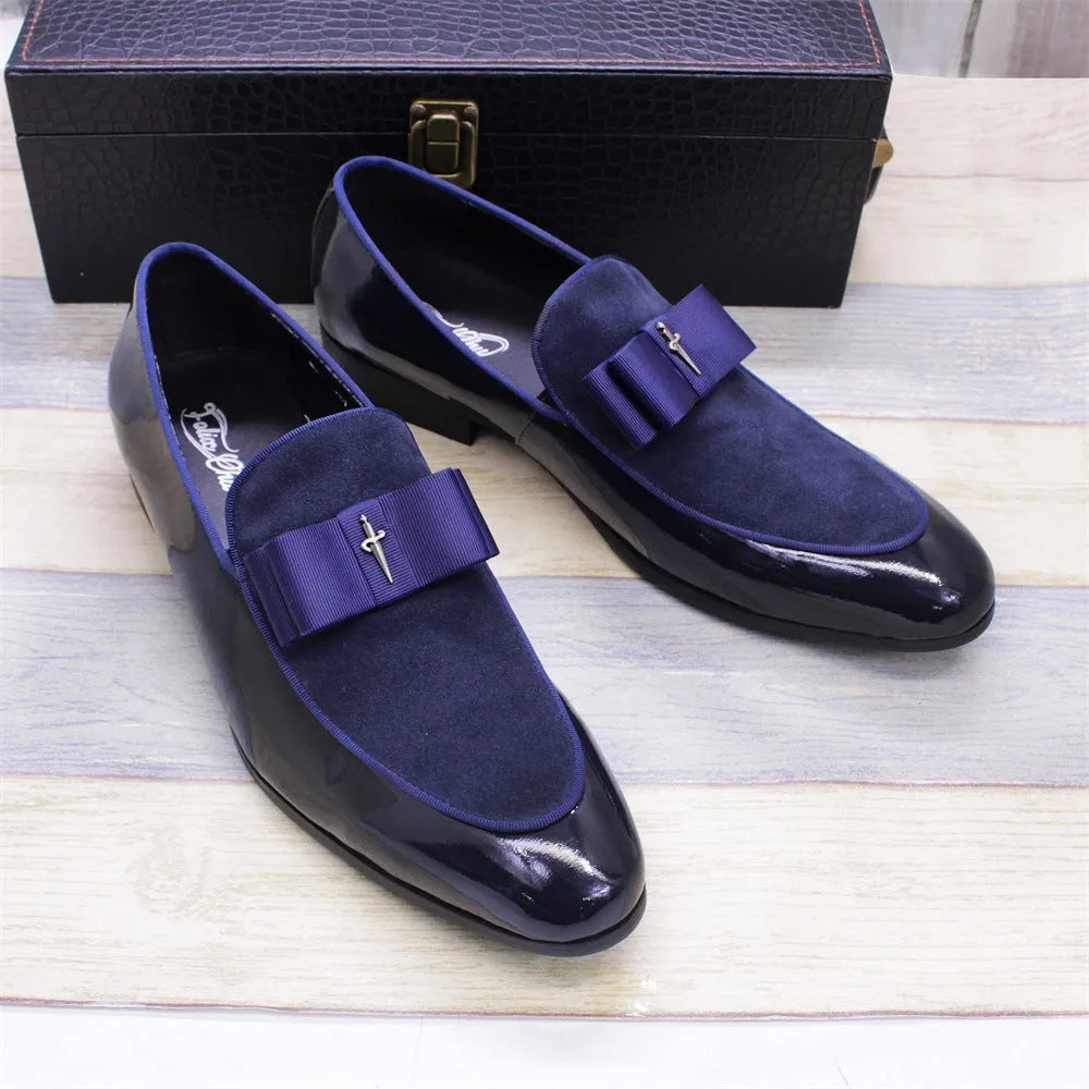 Men's black patent leather shoes with a gold tassel detail on a rubber sole.